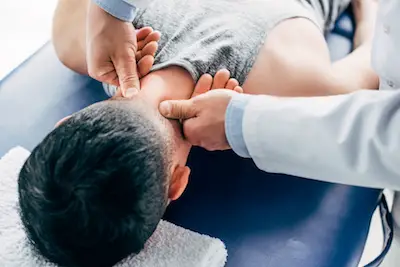 top chiropractor with patient on table